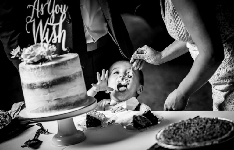 A young child is fed cake during a summer wedding at the YMCA of the Rockies in Estes Park. Colorado