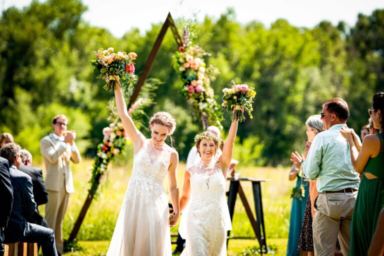 Two brides walk down the aisle