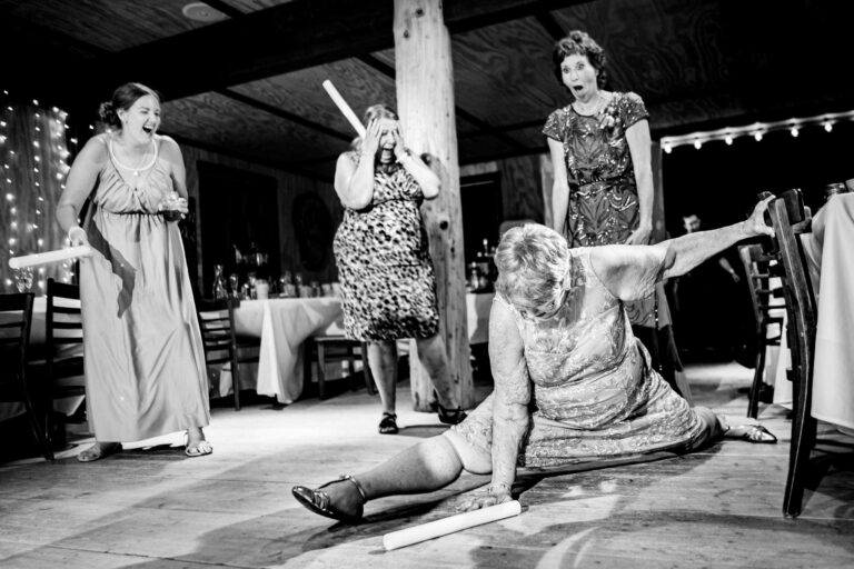 A grandmother does the splits on the dancefloor, shocking her adult daughter whose jaw is hanging open with her hands to her face in disbelief