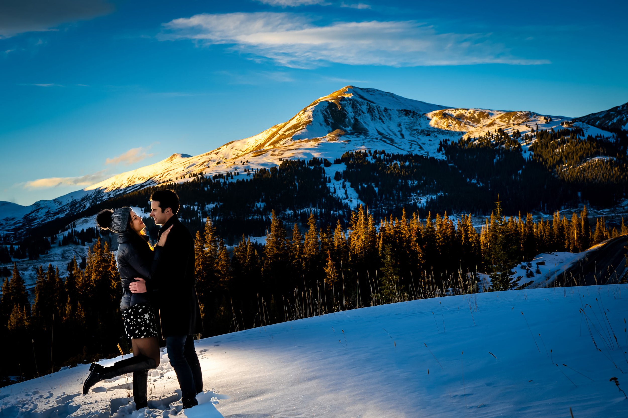 Newly engaged couple celebrate their proposal during a portrait with snowcapped mountains in the background, Winter Engagement Session, Winter Engagement Photos, Engagement Photos Inspiration, Engagement Photography, Engagement Photographer, Winter Engagement Photos, Proposal Photos, Proposal Photographer, Proposal Photography, Winter Proposal, Mountain Proposal, Proposal Inspiration, Summit County engagement session, Summit County engagement photos, Summit County engagement photography, Summit County engagement photographer, Summit County engagement inspiration, Colorado engagement session, Colorado engagement photos, Colorado engagement photography, Colorado engagement photographer, Colorado engagement inspiration, Clinton Gulch Engagement