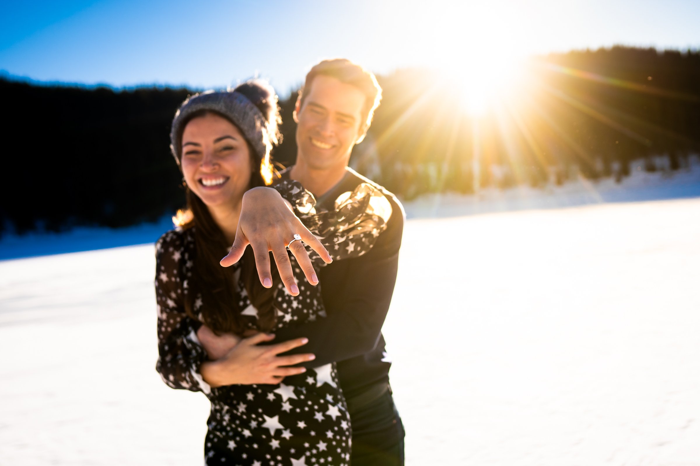 Newly engaged couple celebrate their proposal on a frozen lake with snowcapped mountains in the background, Engagement Session, Engagement Photos, Engagement Photos Inspiration, Engagement Photography, Engagement Photographer, Winter Engagement Photos, Proposal Photos, Proposal Photographer, Proposal Photography, Winter Proposal, Mountain Proposal, Proposal Inspiration, Summit County engagement session, Summit County engagement photos, Summit County engagement photography, Summit County engagement photographer, Summit County engagement inspiration, Colorado engagement session, Colorado engagement photos, Colorado engagement photography, Colorado engagement photographer, Colorado engagement inspiration, Clinton Gulch Engagement
