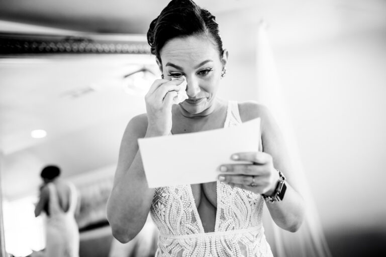 A bride tears up reading a letter during her wedding at Boulder Creek Wedgewood