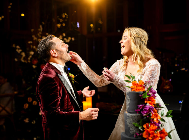 Newlyweds feed each other cake during their wedding at Donovan Pavilion in Vail, Colorado