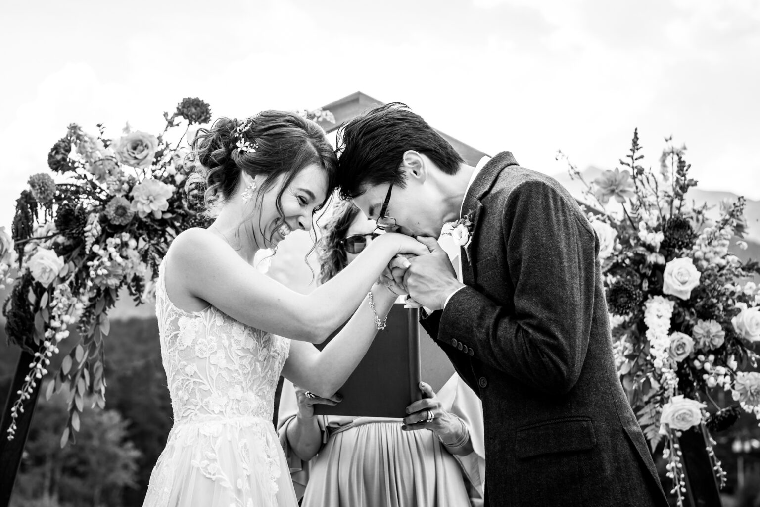 Groom kisses the bride during their wedding ceremony at Wild Basin Lodge in Estes Park