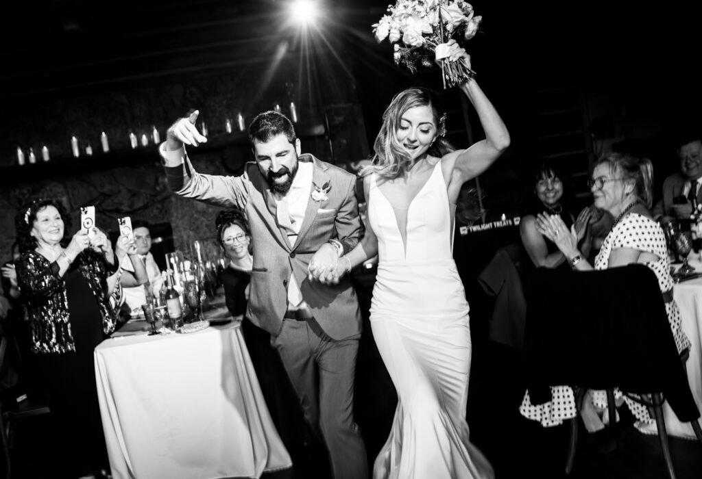 Bride and groom dance into their grand entrance during their wedding reception.