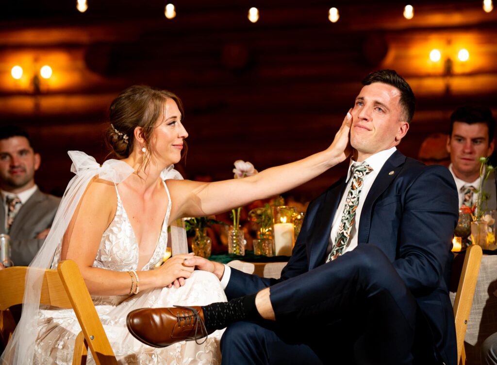 A bride and groom shed a tear during an intimate documentary wedding photography style at the Evergreen Lake House in Evergreen, Colorado