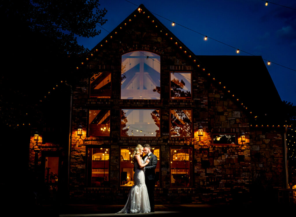 Documentary style wedding portrait of a bride and groom at dusk at Della Terra Mountain Chateau in Estes Park