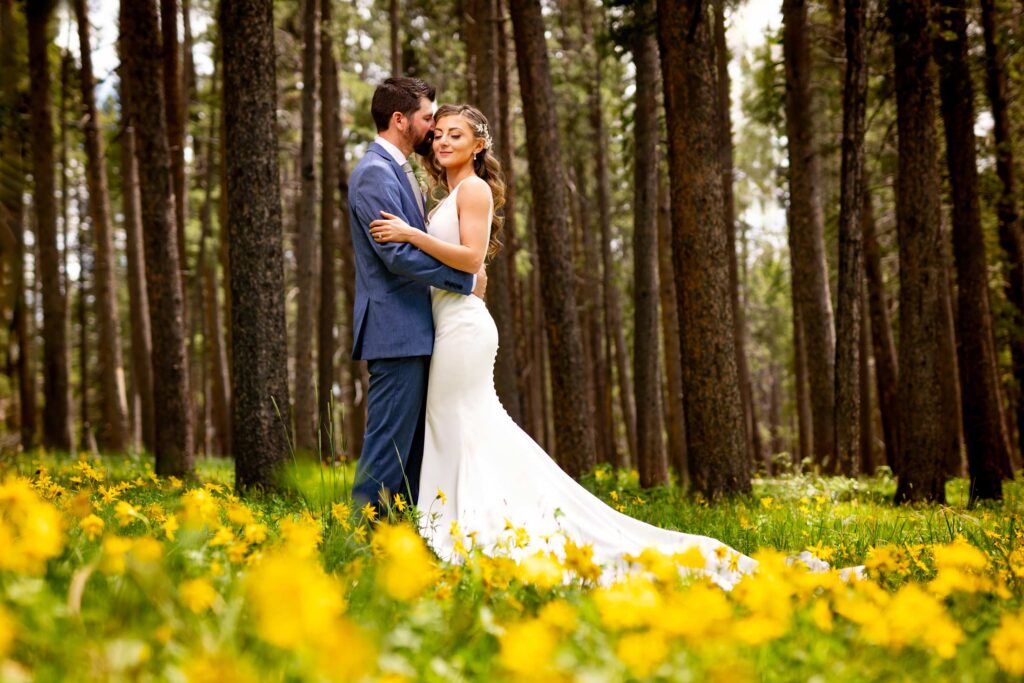 A bride and groom embrace amid wildflowers during their Dao House wedding