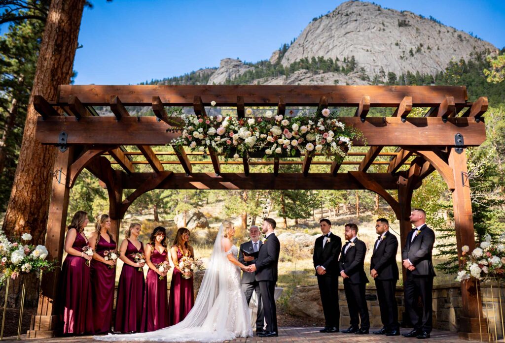 A bridal party stands atop a brick stage during a wedding ceremony at Della Terra Mountain Chateau