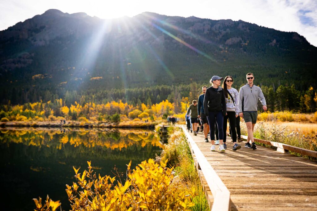 Wedding guest of a Dao House wedding walk around Lily Lake Trail in the fall in Rocky Mountain National Park