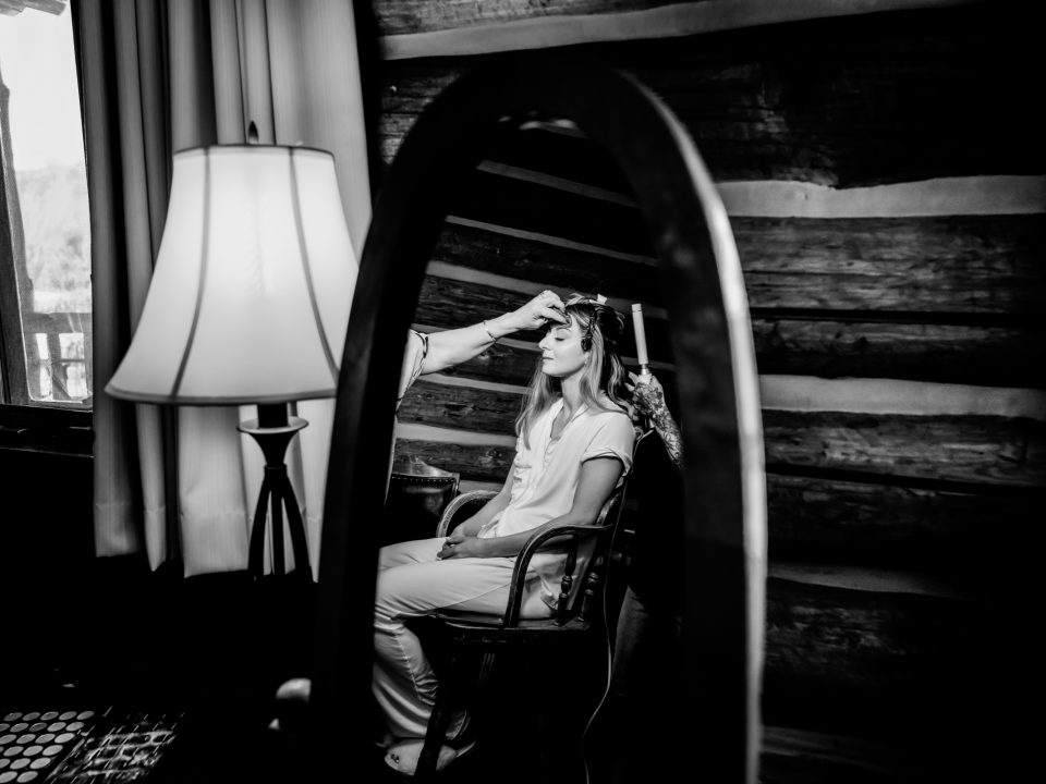 A bride has her makeup done in a Dao House bridal suite during her wedding