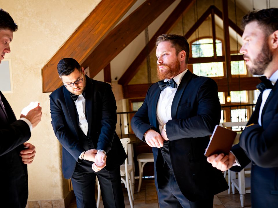 Groomsmen get ready together before the start of the wedding ceremony at Della Terra Mountain Chateau