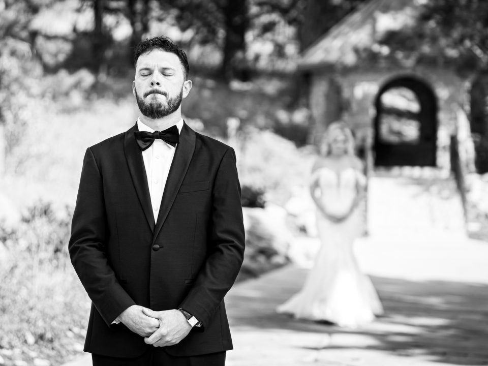 A groom waits to see his bride during first look at their Della Terra Mountain Chateau wedding