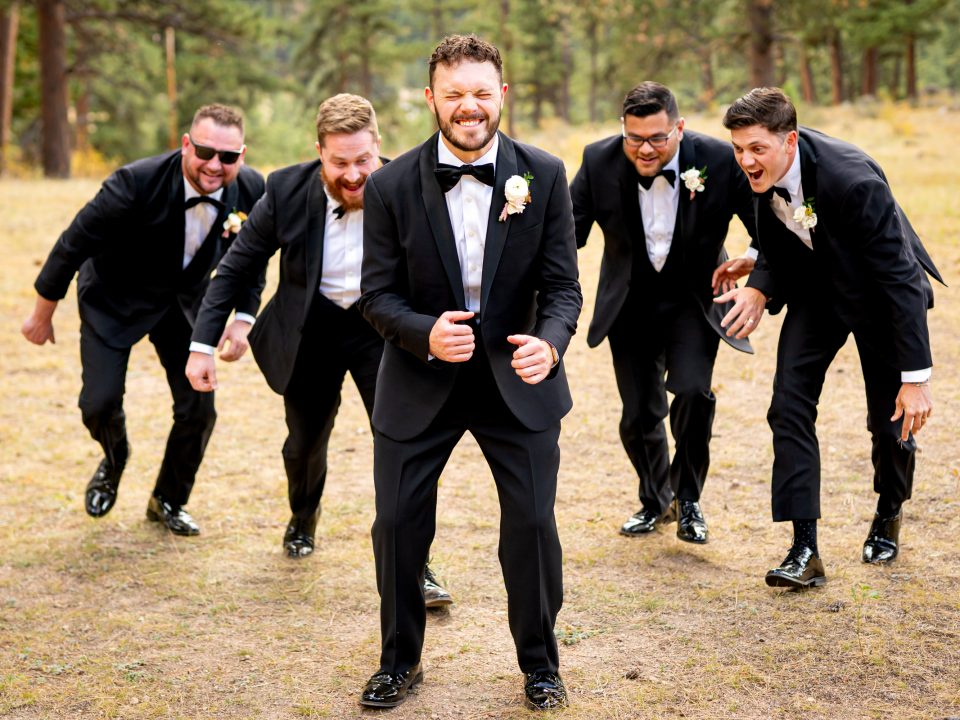 A groom anxiously waits to be tackled by his groomsmen during his Della Terra Mountain Chateau wedding