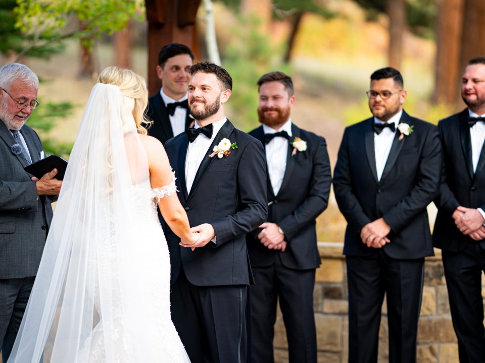 A groom smiles during his wedding ceremony at Della Terra Mountain Chateau