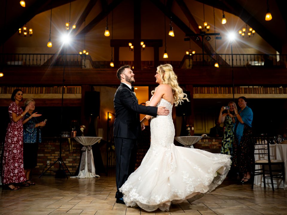 A bride and groom twirl on the dance floor during their Della Terra Mountain Chateau wedding