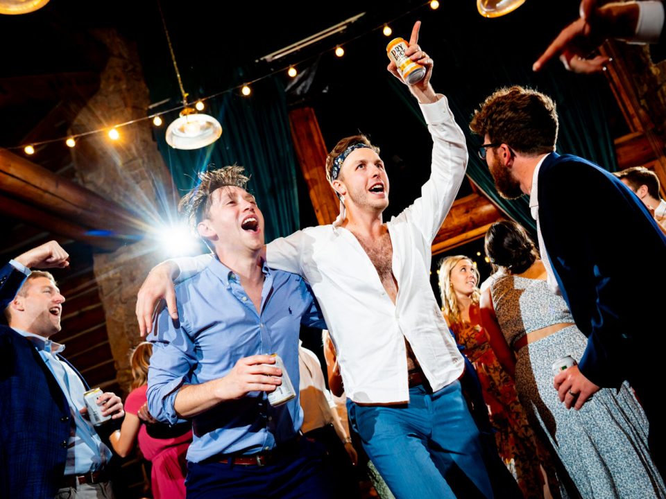 A groom dances with friends in the reception hall at Dao House during his wedding